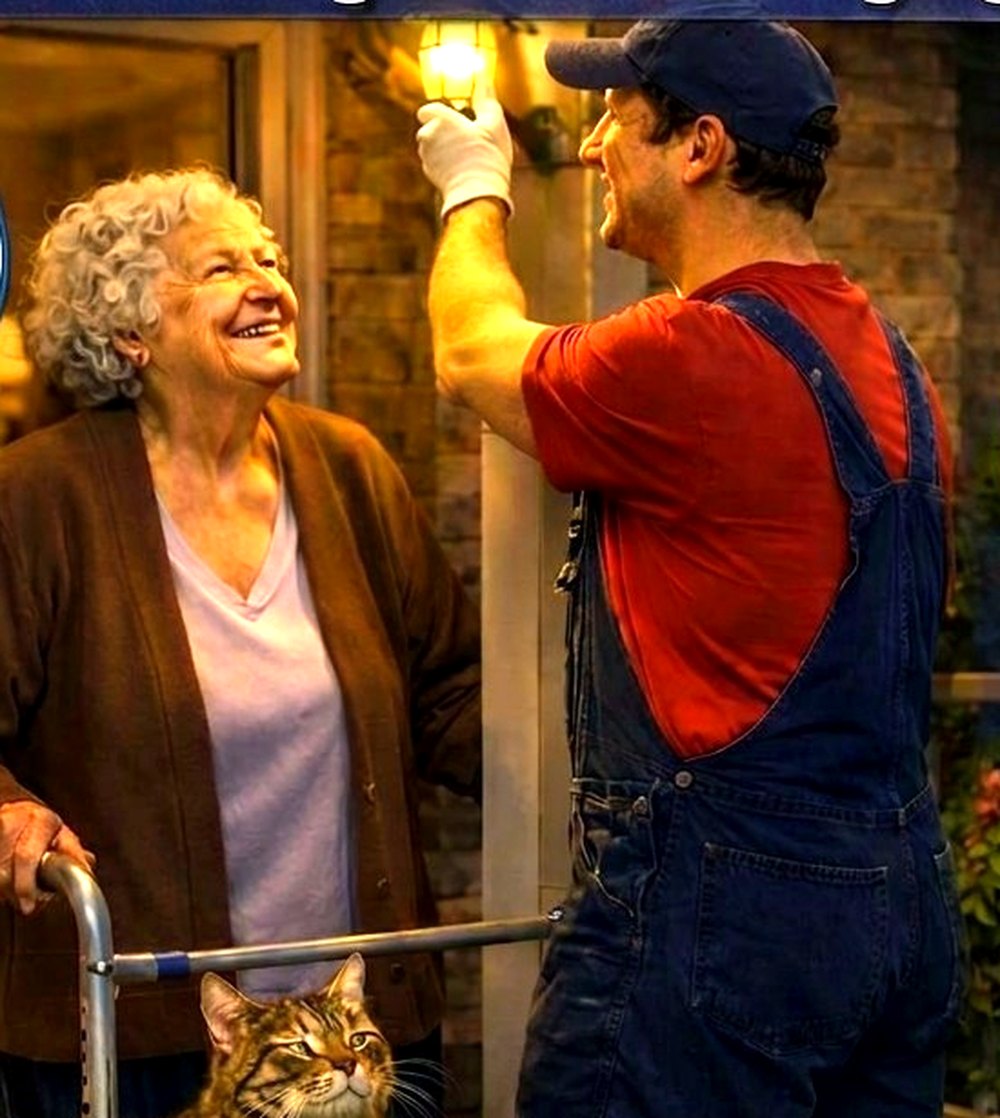 Honey It's Done handyman fitting a new porch light for an elderly woman using a walker at her front door, senior home repair services from Windsor to London Ontario